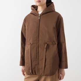 Model wearing Max Mara Cube Charme Reversible Water-Repellent Jacket in Hazelnut with fixed hood, zip fastening and side pockets