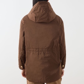 Model wearing Max Mara Cube Charme Reversible Water-Repellent Jacket in Hazelnut, back view, fixed hood and drawstring waist visible.