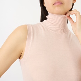 Model wearing Max Mara Sportmax pink sleeveless turtleneck knit top in 100% virgin wool, close-up detail shot