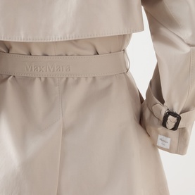 Max Mara Cube silver cotton-blend raincoat close-up showing embossed logo belt and buckled cuff detail