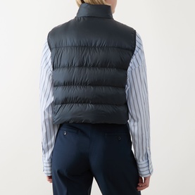 Model wearing Max Mara Cube Favilla Padded Gilet in midnight blue, back view, styled with a blue striped shirt and navy trousers.
