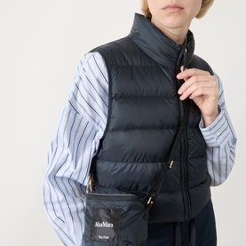 Model wearing Max Mara Cube Favilla Padded Gilet in Midnight Blue with high neck and zip fastening, styled with a striped shirt and small crossbody