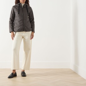Model wearing Max Mara Cube Greenh Padded Hooded Jacket in kaki, styled with cream wide-leg trousers and black loafers.