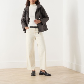 Model wearing Max Mara Cube Greenh Padded Hooded Jacket in kaki, styled with cream wide-leg jeans, white roll-neck and black loafers
