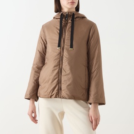 Model wearing Max Mara Cube honey quilted hooded jacket with black drawstring detail, styled with cream wide-leg trousers