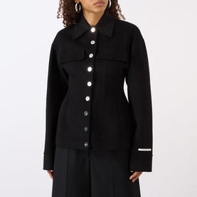 Model wearing Max Mara Sportmax Arena Button-Down Short Coat in black, featuring pearl buttons, pointed collar, and logo cuff detail, styled with