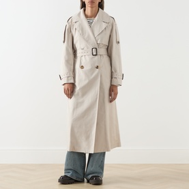Model wearing Max Mara Cube Coro Trench Coat in silver, double-breasted with buckle belt, styled with striped top and wide-leg jeans