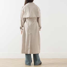 Model wearing Max Mara Cube Coro Trench Coat in silver, showing back view with buckle belt, storm flap and centre-back slit, styled with wide-leg