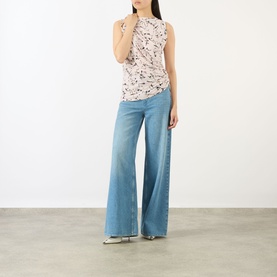 Model wearing Max Mara Sportmax antique rose floral sleeveless top with ruched detail, styled with wide-leg light blue jeans.