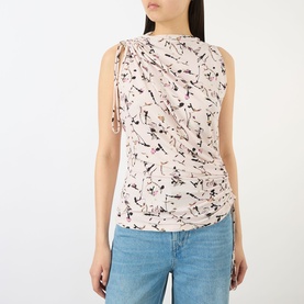 Model wearing Max Mara Sportmax antique rose floral sleeveless top with ruched shoulder detail, styled with light blue jeans.