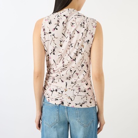 Model wearing Max Mara Sportmax Antique Rose sleeveless top with abstract floral print, ruched side detail, back view, styled with light blue jeans.