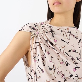 Model wearing Max Mara Sportmax antique rose floral print sleeveless top with gathered knot detail at shoulder, in viscose blend.