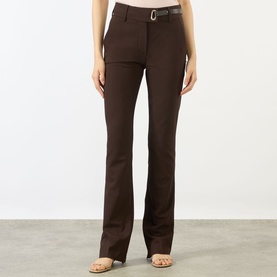 Model wearing Max Mara Sportmax cocoa bootcut trousers with a belt, styled with strappy heeled sandals.