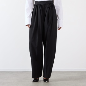 Model wearing Max Mara Sportmax Zorro Wide-Leg Trousers in black with gathered front detail and tapered hem, styled with white top and black heels.