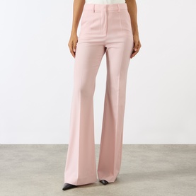 Model wearing Max Mara Sportmax Antique Rose wide-leg flared trousers in virgin wool, high-waisted with a clean front finish.