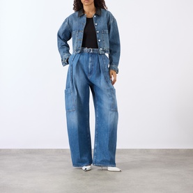 Model wearing Max Mara Sportmax Midnight Blue wide-leg denim cargo trousers with pleated front, styled with cropped denim jacket and white shoes.