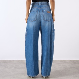 Model wearing Max Mara Sportmax midnight blue wide-leg cotton cargo jeans, rear view showing utility pockets and relaxed fit