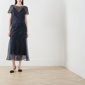 Model wearing Piano Forte Mela Organza Top in Midnight Blue with sheer short sleeves over cami base, styled with a matching midi skirt and navy heels.