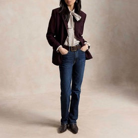 Model wearing Polo Ralph Lauren Midnight Merlot blazer, styled with striped bow-neck shirt, dark jeans, and brown buckled shoes.