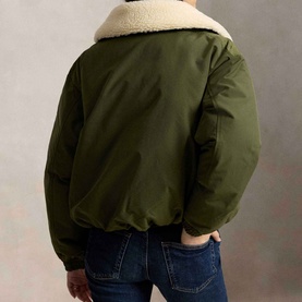 Model wearing Polo Ralph Lauren New Olive coat, rear view, sherpa collar, bomber silhouette, styled with blue jeans