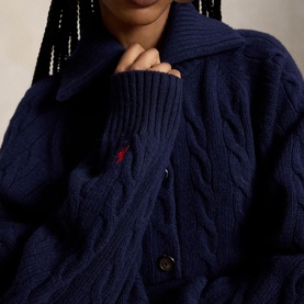 Model wearing Polo Ralph Lauren Hunter Navy cable-knit cardigan, featuring spread collar and signature embroidered pony logo