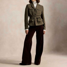 Model wearing Polo Ralph Lauren Belted Tweed Utility Jacket in Loden Herringbone with gold-tone buckle belt, styled with dark wide-leg trousers and