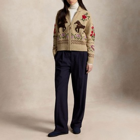Model wearing Polo Ralph Lauren multi cardigan with horse and floral intarsia knit, styled with navy trousers and white turtleneck