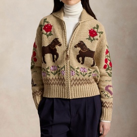 Model wearing Polo Ralph Lauren multi cardigan with zip front, horse and floral intarsia knit pattern, styled with navy trousers and white turtleneck
