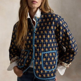 Model wearing Polo Ralph Lauren Navy Multi floral quilted jacket with blue trim pockets, styled with a white shirt underneath