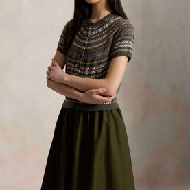 Model wearing Polo Ralph Lauren Hybrid Fair Isle Flared Dress in Olive Multi, with Fair Isle knit bodice, short sleeves, and A-line skirt