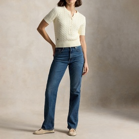 Model wearing Polo Ralph Lauren Clubhouse Cream cable-knit short-sleeve top, styled with blue straight-leg jeans and beige flats.