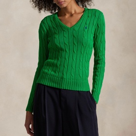 Model wearing Polo Ralph Lauren Preppy Green cable-knit V-neck jumper with embroidered logo, styled with navy wide-leg trousers.