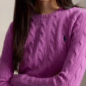 Model wearing Polo Ralph Lauren Pony Logo Cable Knitted Sweater in Thistle Pink, featuring cable-knit construction and embroidered Pony logo