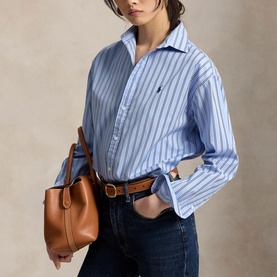 Model wearing Polo Ralph Lauren blue and white stripe shirt, styled with dark jeans and brown leather tote bag