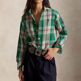 Model wearing Polo Ralph Lauren green and cream plaid shirt with navy skirt and western buckle belt