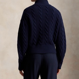 Model wearing Polo Ralph Lauren Hunter Navy cable-knit turtleneck sweater, back view, styled with navy trousers