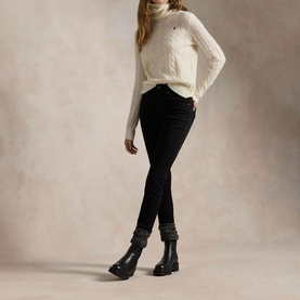 Model wearing Polo Ralph Lauren Authentic Cream cable-knit turtleneck jumper, styled with black skinny jeans and black ankle boots.