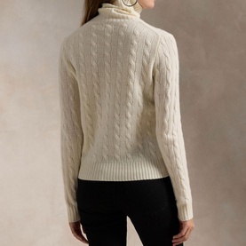 Model wearing Polo Ralph Lauren Authentic Cream cable-knit turtleneck sweater, back view, styled with black trousers