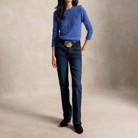 Model wearing Polo Ralph Lauren Nimes Blue Heather cable-knit jumper, styled with dark wash bootcut jeans and a western belt.