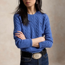 Model wearing Polo Ralph Lauren Nimes Blue Heather cable-knit sweater, styled with dark denim jeans and a western belt.