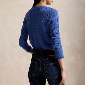 Model wearing Polo Ralph Lauren Nimes Blue Heather cable-knit jumper, styled with dark wash jeans, seen from the back.