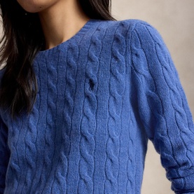 Model wearing Polo Ralph Lauren cable-knit jumper in Nimes Blue Heather, close-up showing textured cable detail and crew neckline
