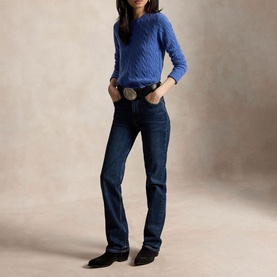 Model wearing Polo Ralph Lauren Nimes Blue Heather cable-knit jumper, styled with dark wash bootcut jeans and black western boots.