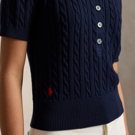 Model wearing Polo Ralph Lauren Hunter Navy cable-knit short-sleeve sweater with button placket and embroidered Polo Pony logo