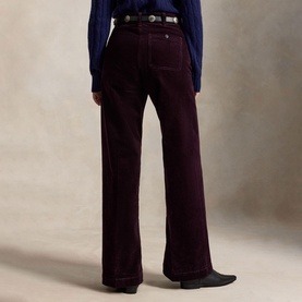 Model wearing Polo Ralph Lauren Midnight Merlot wide-leg corduroy trousers, styled with a blue top and black leather belt and cowboy boots.