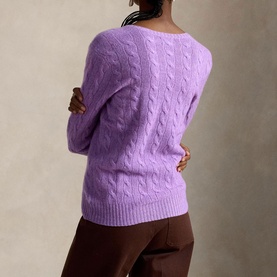 Model wearing Polo Ralph Lauren cable-knit jumper in Amethyst Falls Heather, back view, styled with dark brown trousers