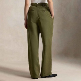 Model wearing Polo Ralph Lauren Belted Pleated High-Rise Straight Leg Trousers in olive, rear view, styled with black loafers.