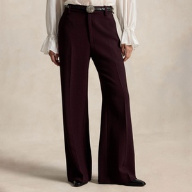 Model wearing Polo Ralph Lauren Midnight Merlot wide-leg trousers with a western belt buckle and white ruffled blouse.
