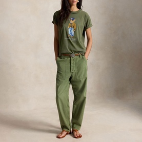 Model wearing Polo Ralph Lauren Dense Olive T-Shirt with Polo Bear graphic, styled with matching olive trousers and brown belt.