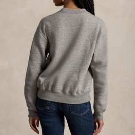Model wearing Polo Ralph Lauren Dark Vintage Heather sweat top, rear view, styled with blue jeans.